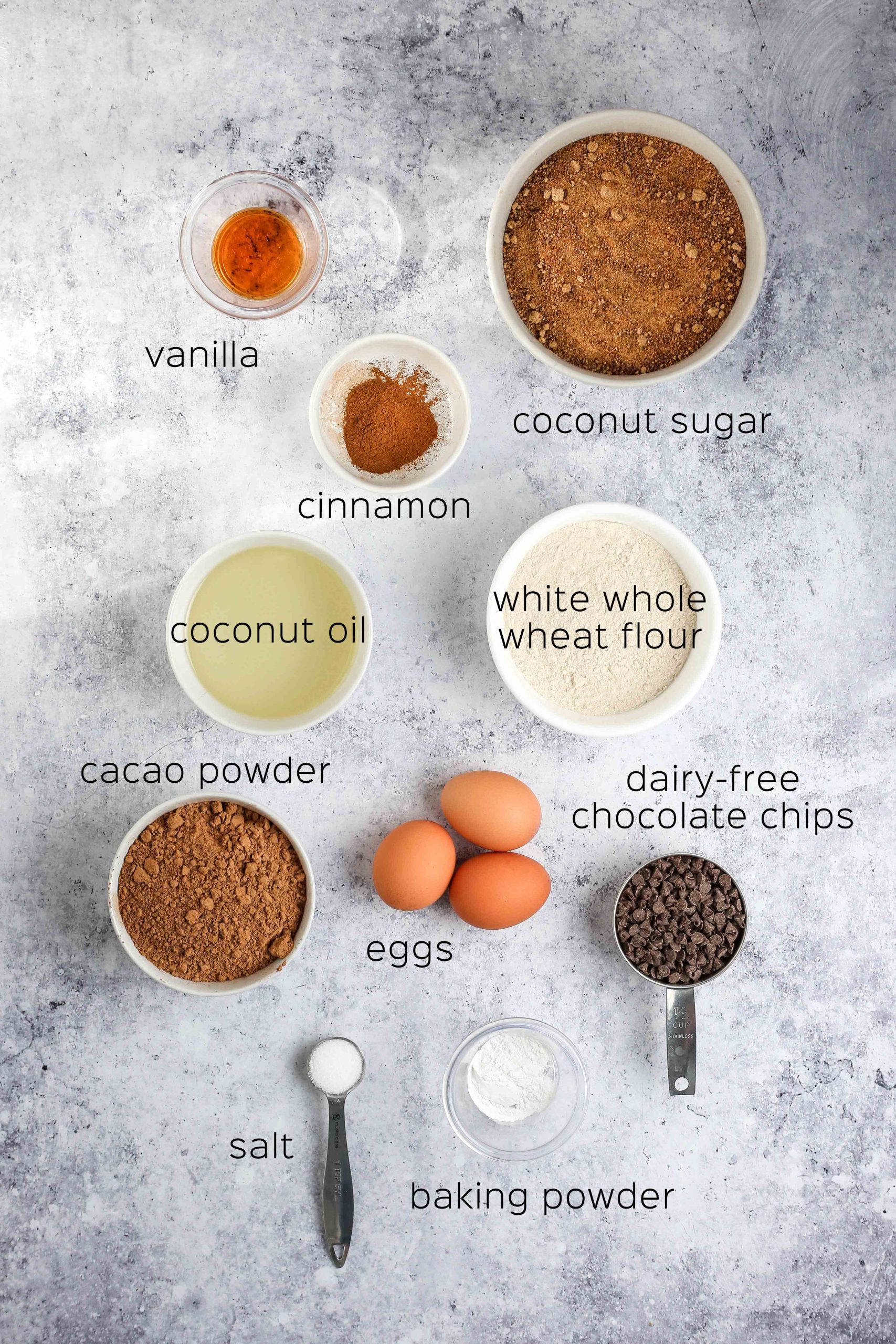 ingredients to make dairy free brownies, including whole wheat flour, coconut oil, and eggs