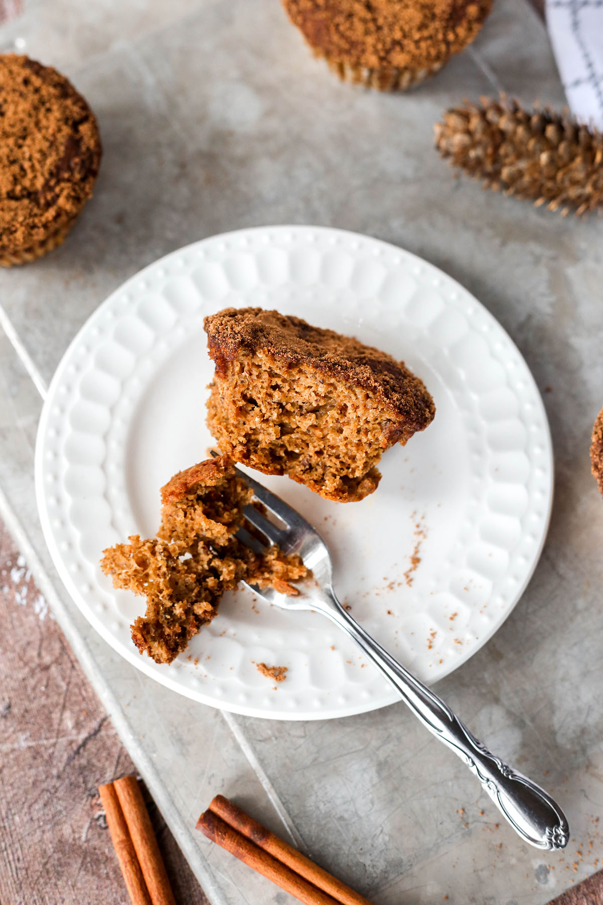 a pumpkin muffin on a plate with a fork digging in