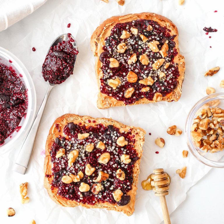 two slices of toast with peanut butter and chia jam on top
