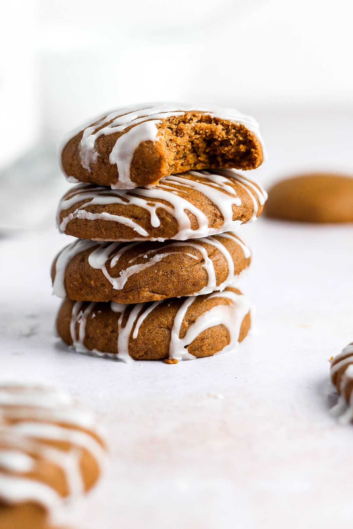 a stack of four gluten free pumpkin cookies with the top one missing a bite