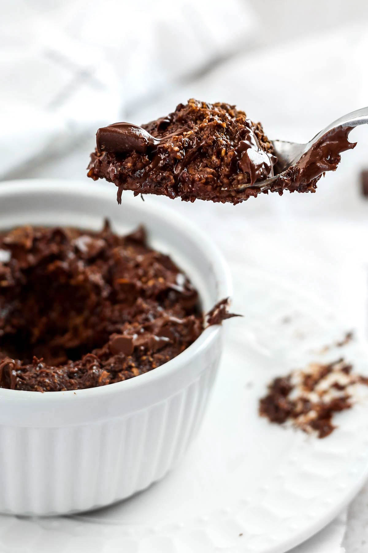 a spoonful of chocolate baked oats with melted chocolate on top.