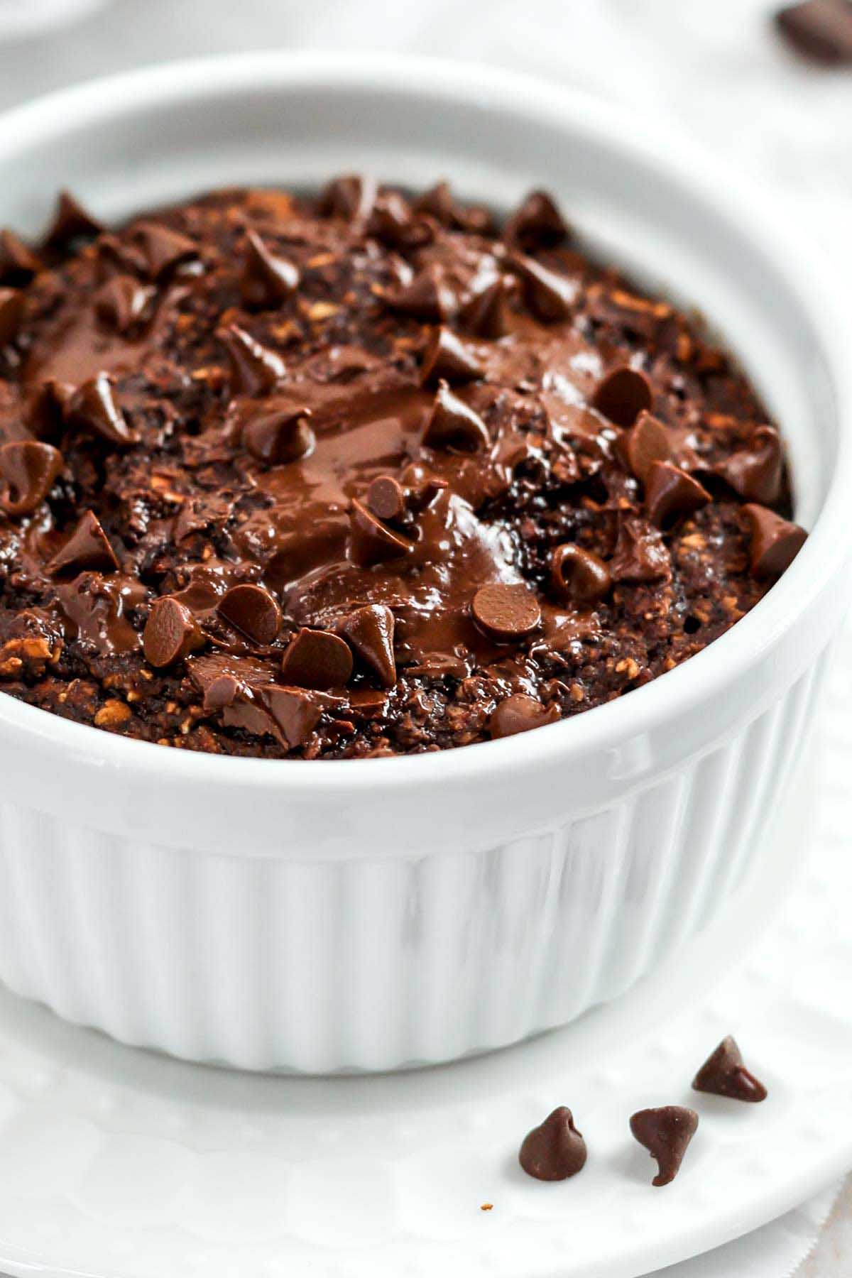 a close-up photo of chocolate baked oats with melted chocolate on top, fresh out of the oven.
