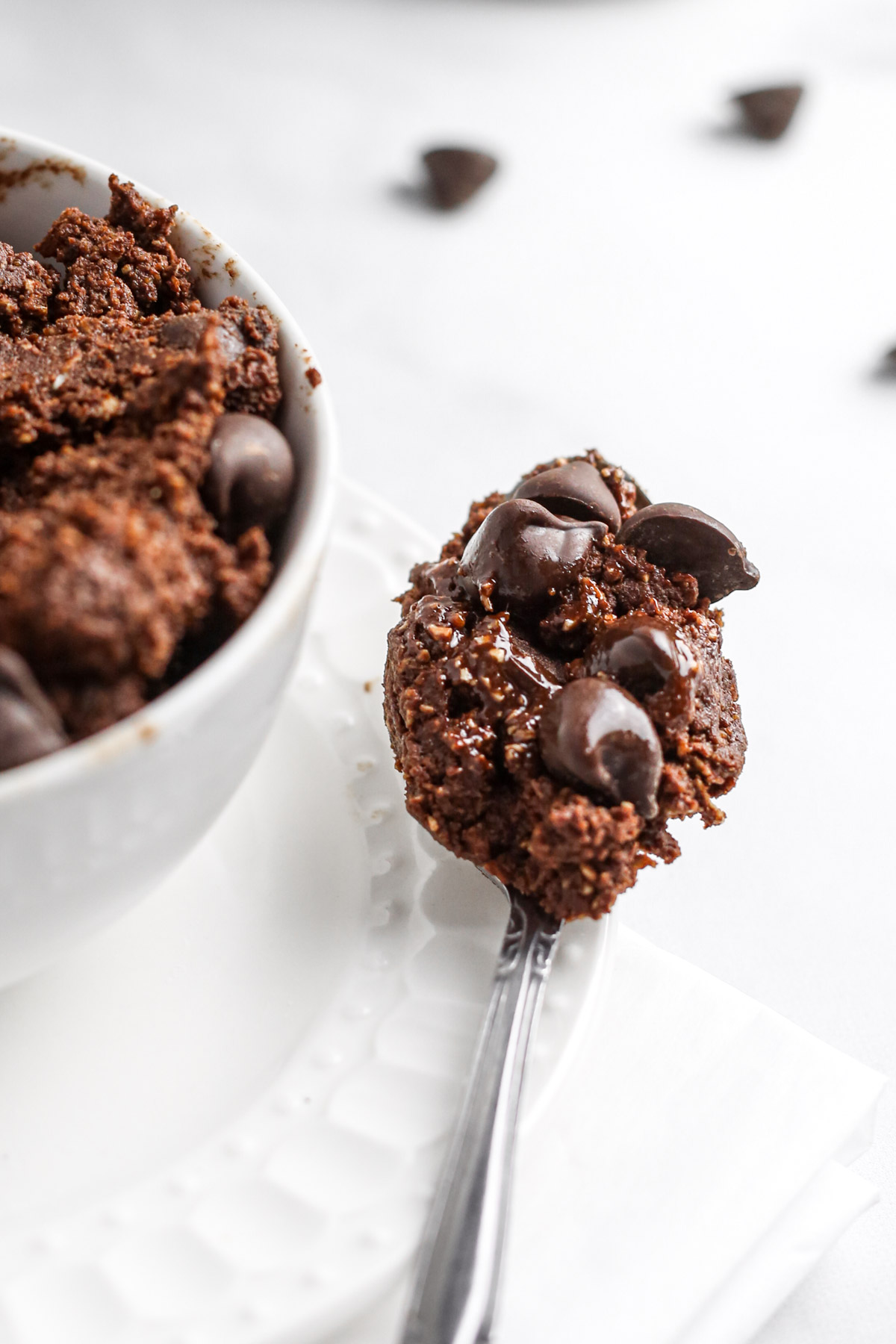 a spoonful of the edible brownie batter with melted vegan chocolate chips.