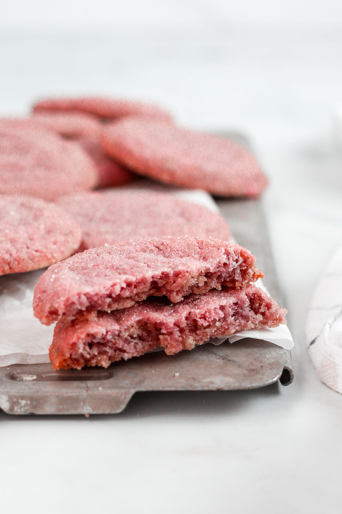 Two halves of pink cookies stacked on top of each other, showing the soft and chewy texture of the cookies.