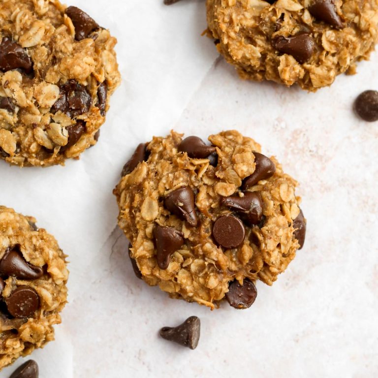 healthy banana oatmeal cookies on parchment paper with chocolate chips.