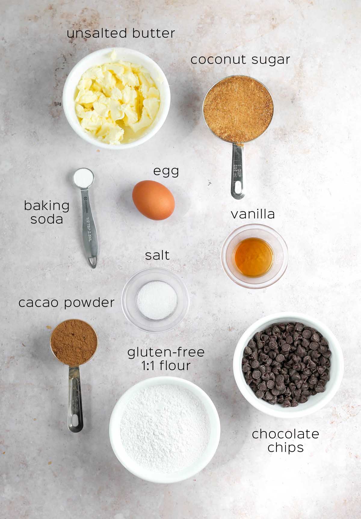 all ingredients to make the cookies, prepared in small bowls and measuring cups on a table.