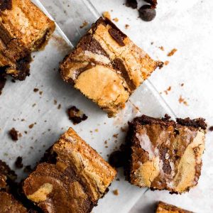 multiple brownie blondies on a gray tray with a marble swirl.