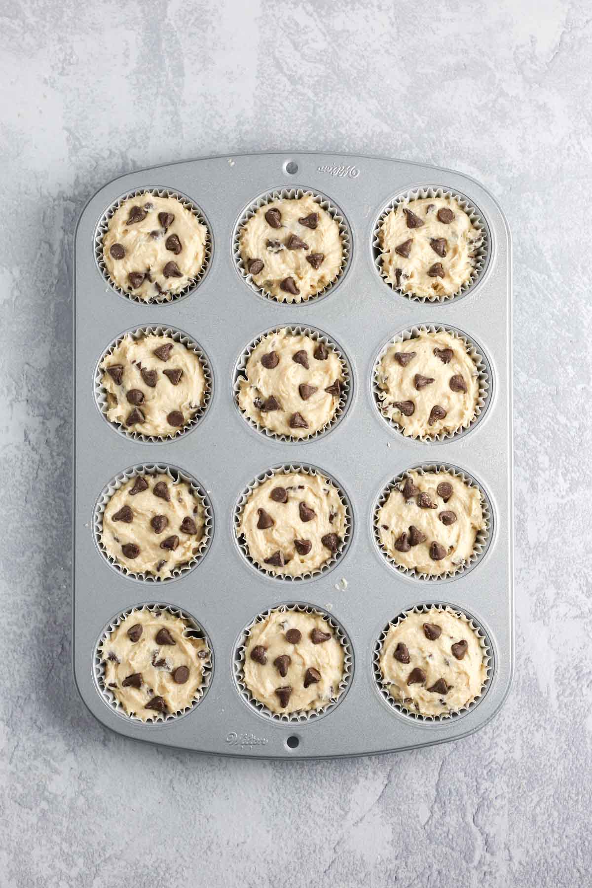 adding extra chocolate chips into the muffin batter before baking.