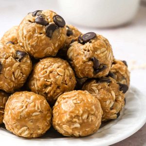 a stack of vegan peanut butter oatmeal balls on a plate.