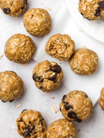 many peanut butter oatmeal balls on parchment paper, shown from above.