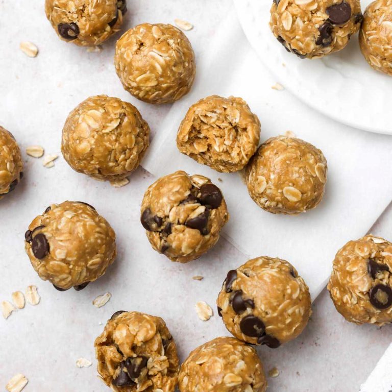 many peanut butter oatmeal balls on parchment paper, shown from above.