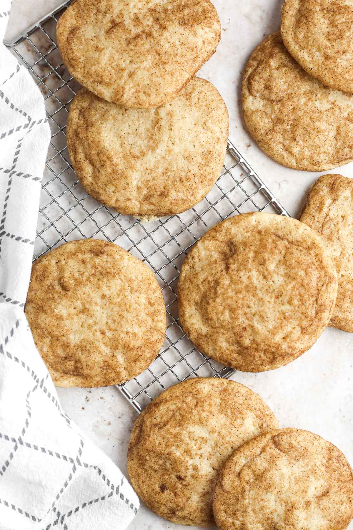 baked snickerdoodle cookies on a wire tray.