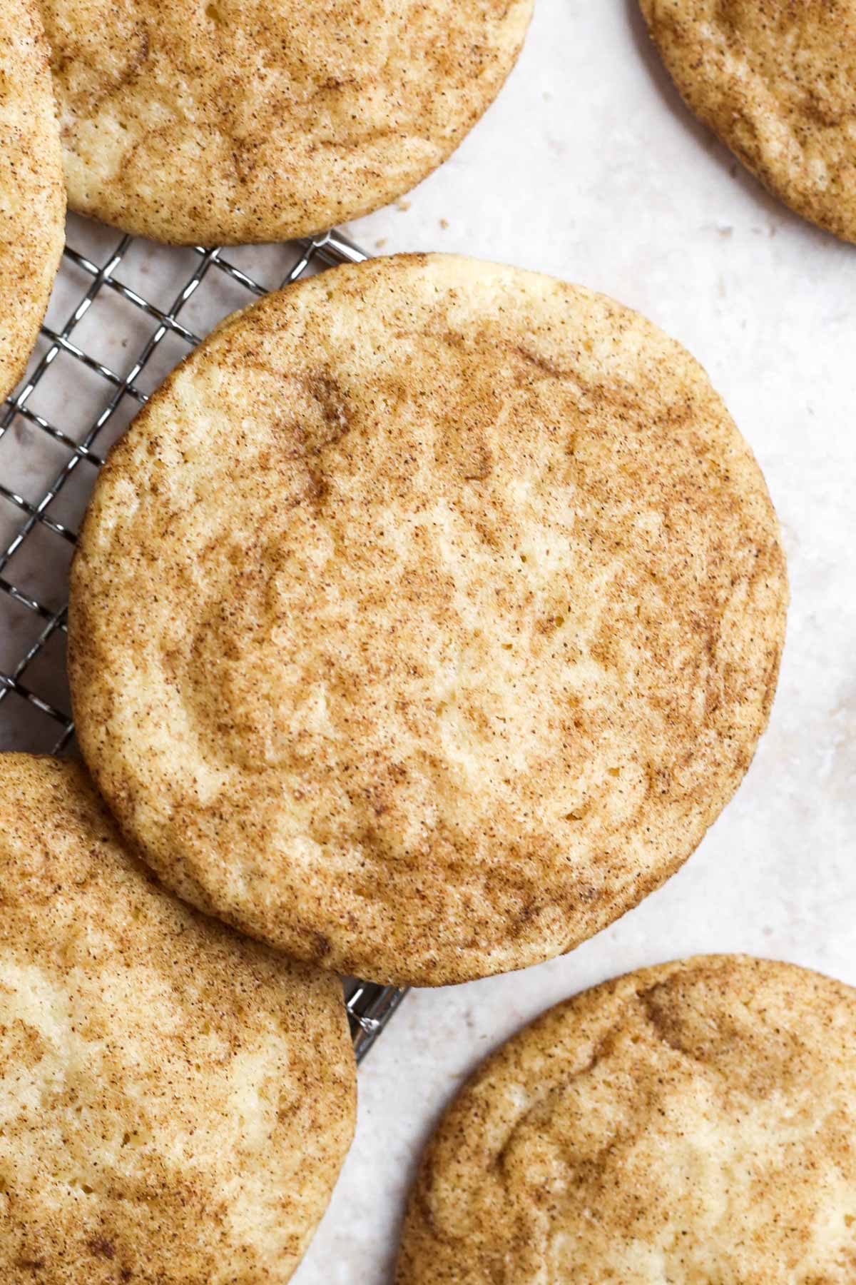 close up of the top of a baked snickerdoodle cookie without cream of tartar, showing the cinnamon sugar coating.