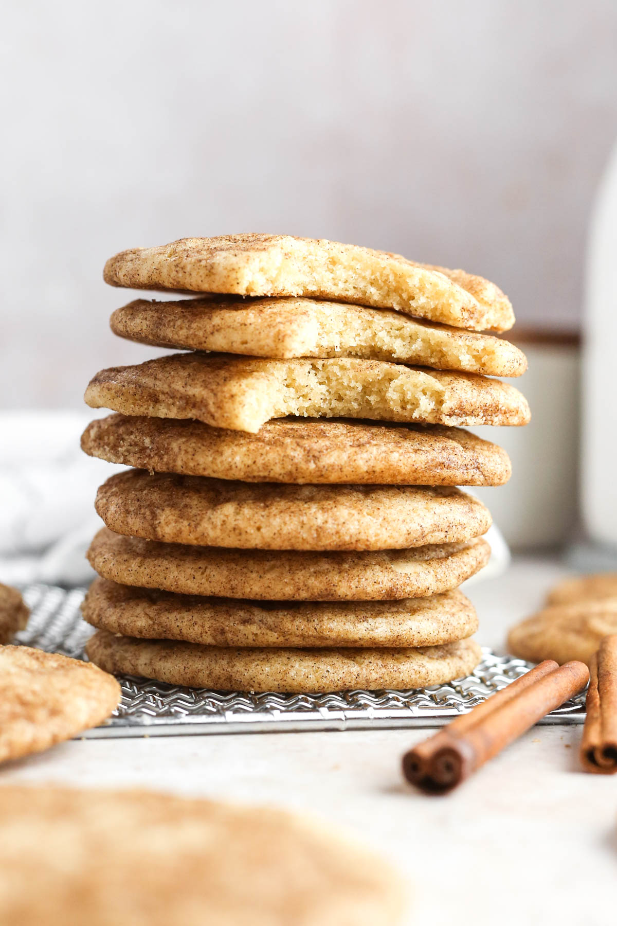 a stack of snickerdoodle cookies without cream of tartar, with the top cookies missing a bite.