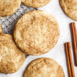 easy snickerdoodles without cream of tartar on a marble table with cinnamon sticks.