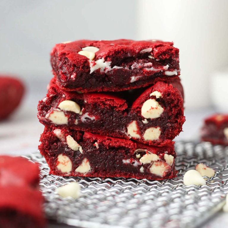 a stack of three fudgy red velvet cake mix brownies on a tray.