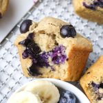 healthy banana blueberry muffins on a wire tray.
