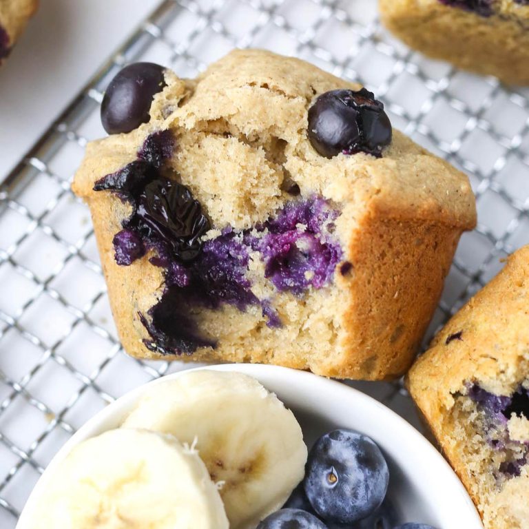 close-up of a healthy banana blueberry muffin with purple blueberries inside.