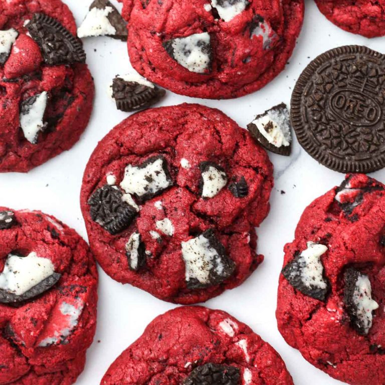 multiple oreo red velvet cookies shown from above with chunks of oreos baked into the tops of the cookies.