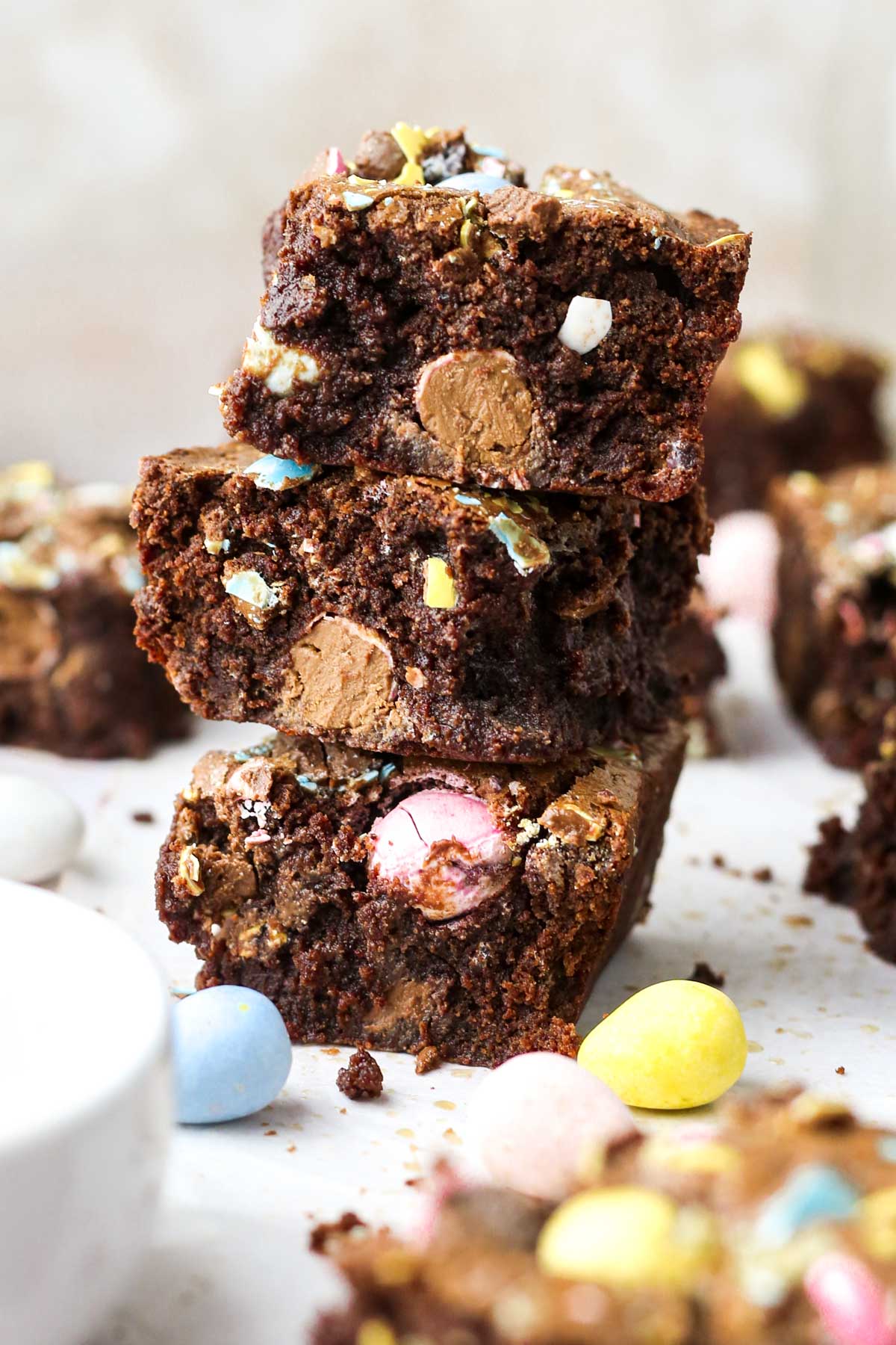 A stack of three brownies shown from the side, with chocolate eggs baked in each brownie.