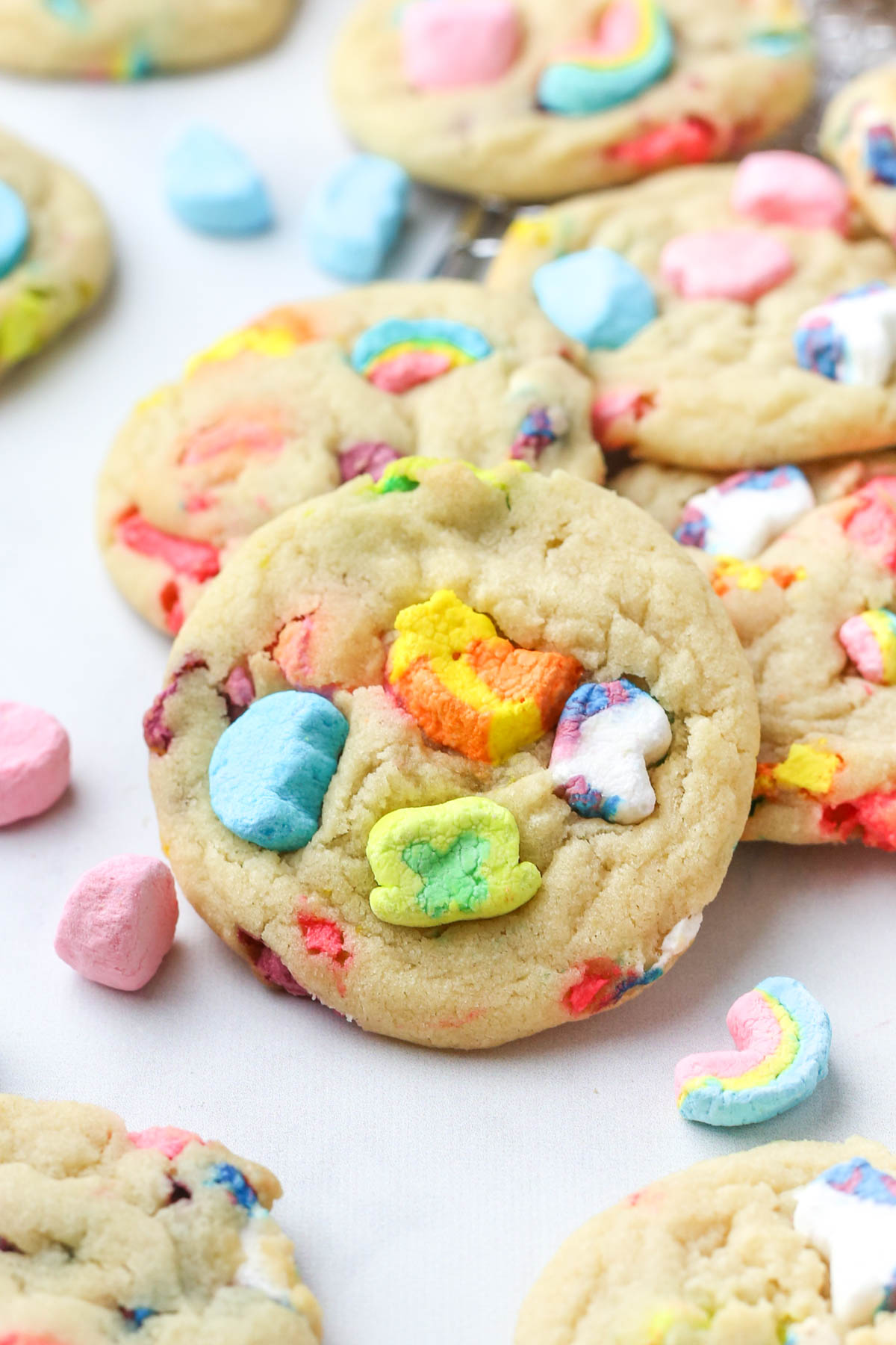 Close-up of a sugar cookie with lucky charms marshmallows in the top.