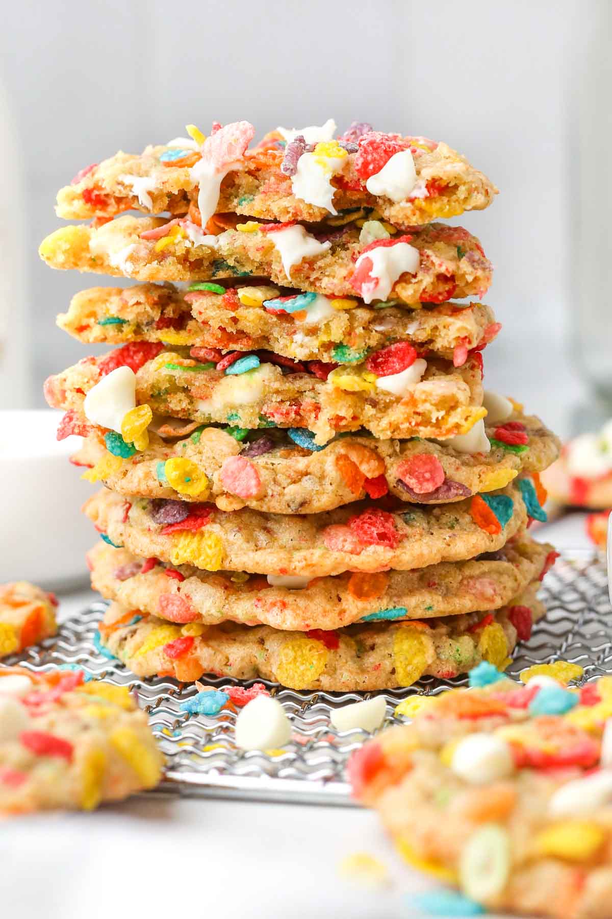 a thick stack of freshly baked cookies with white chocolate chips melting out of the insides.