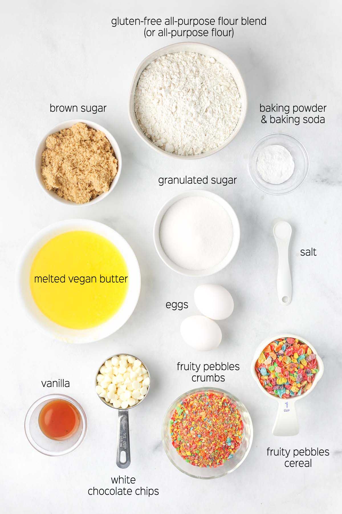 all ingredients to make the cookie recipe shown from above on a marble surface in white dishes.