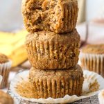 a stack of three healthy banana carrot muffins.