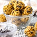 a small glass bowl full of healthy pumpkin protein balls with chocolate chips.