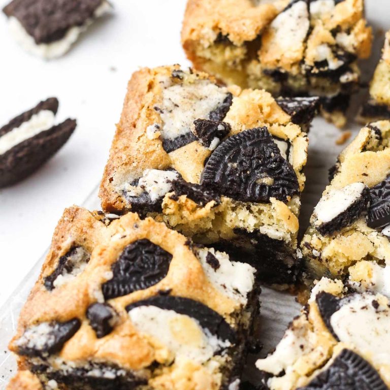 angled photo of cookies and cream oreo blondies on a tray.