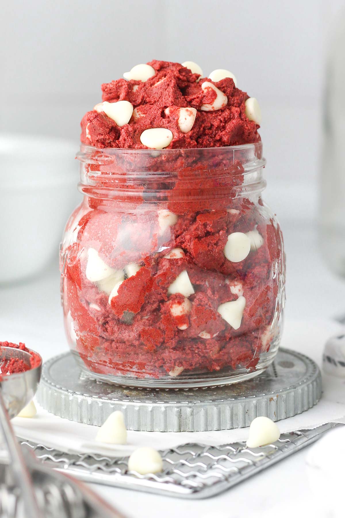 a glass jar shown from the side, full of edible red velvet cookie dough.