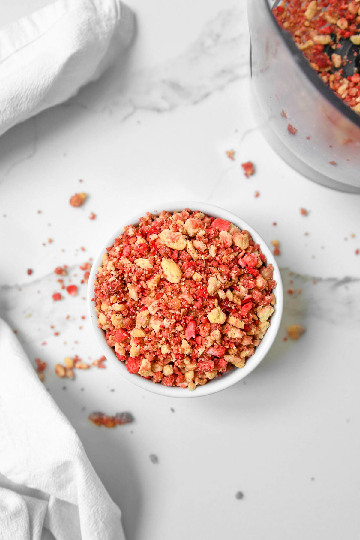 Strawberry crunch crumble topping in small bowl, ready for use.