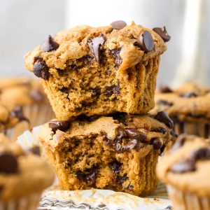 Two easy 3-ingredient pumpkin muffins stacked on top of each other with chocolate chips inside.