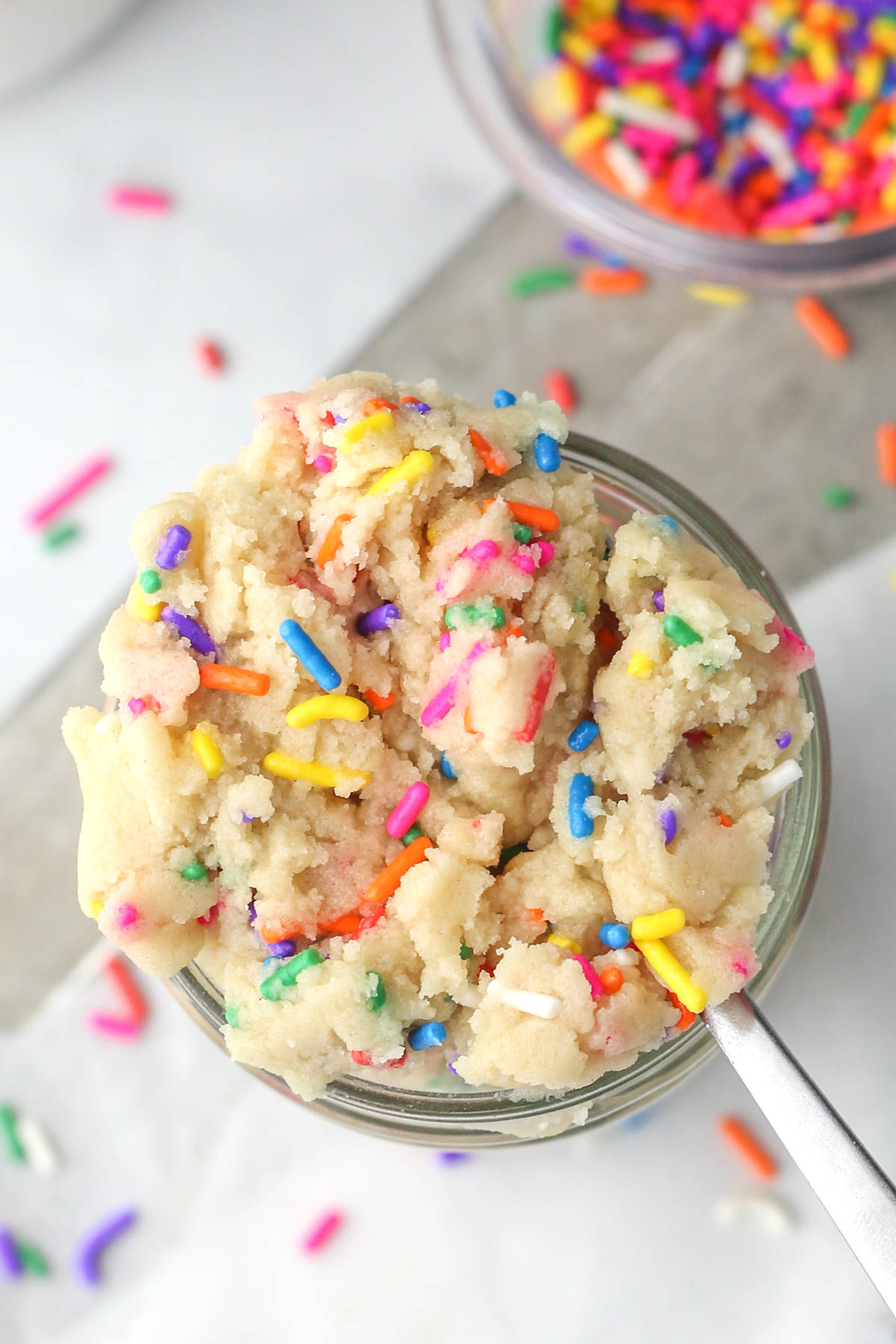 A jar of cookie dough shown from above with sprinkles.